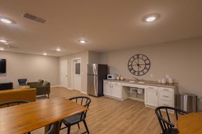 Columbus apartment for rent - A kitchen with a table and chairs in the foreground and a refrigerator in the background.