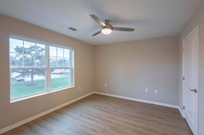 Columbus apartment for rent - A room with a ceiling fan and a large window.