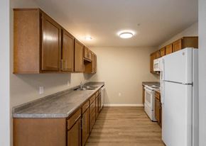 Columbus apartment for rent - A kitchen with wooden cabinets and a white refrigerator.