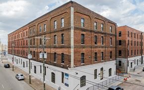 Louisville apartment for rent - A large brick building with a white section on the bottom.