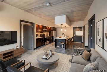 Dayton apartment for rent - A modern living room with a grey couch and a coffee table.