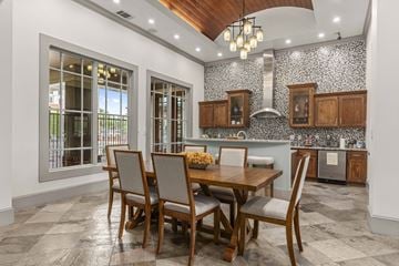 Austin apartment for rent - A kitchen with a table and chairs in front of a window.