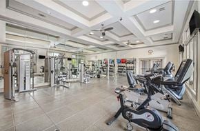 Austin apartment for rent - A spacious gym with a variety of equipment including treadmills, stationary bikes, and weight machines.
