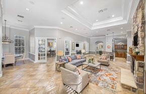 Austin apartment for rent - A spacious living room with a stone fireplace and a large rug.