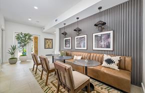 Austin apartment for rent - A modern living room with a brown leather couch and a striped wallpaper.