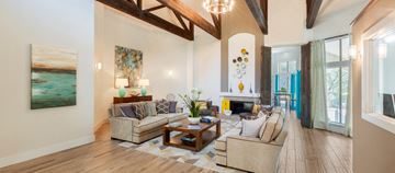 Austin apartment for rent - A living room with a couch, a coffee table, and a painting on the wall.