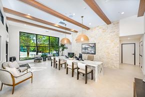 Austin apartment for rent - A modern living room with a stone wall and wooden beams.