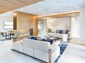 Charlotte apartment for rent - A modern living room with a large sectional sofa and a fireplace.