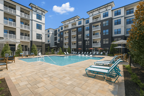 Lawrenceville apartment for rent - A swimming pool surrounded by sun loungers and apartment buildings.