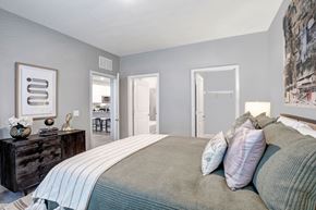 Mcdonough apartment for rent - a bedroom with a large bed and a door to a bathroom