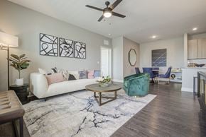 Kannapolis apartment for rent - Open-concept apartment living room and dining area with wood-style flooring at Argento at Kellswater in Kannapolis, NC