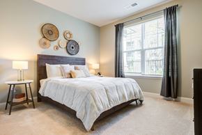 Augusta apartment for rent - a bedroom with a large bed in front of a window