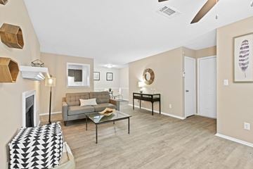 Duluth apartment for rent - a living room with a couch and a coffee table and a fireplace
