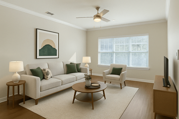 Knoxville apartment for rent - A living room with a white couch, a coffee table, and a painting on the wall.