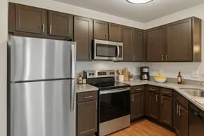 Knoxville apartment for rent - A kitchen with a stainless steel refrigerator and brown cabinets.