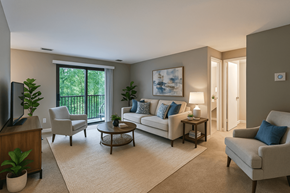 Grand Rapids apartment for rent - A living room with a couch, chairs, and a television.
