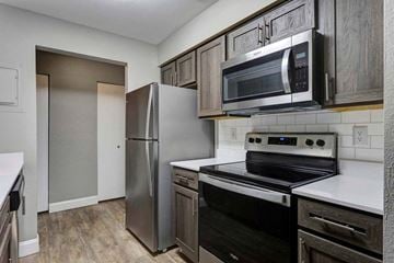 Grand Rapids apartment for rent - a kitchen with wooden cabinets and stainless steel appliances