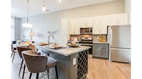 Carmel apartment for rent - A kitchen with a table and chairs in front of it.