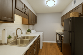 Augusta apartment for rent - A kitchen with a black refrigerator and brown cabinets.