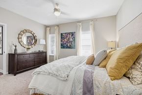 Augusta apartment for rent - A bedroom with a large bed and a dresser with a mirror.