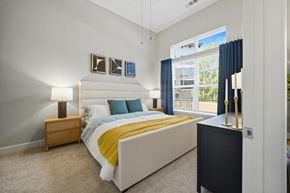 Lawrenceville apartment for rent - A bedroom with a bed, nightstand, and window.