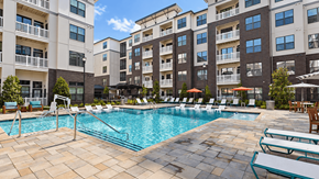 Lawrenceville apartment for rent - Swimming pool with entry steps, handrails, sun-shelf loungers and poolside seating at Argento at Sugarloaf.