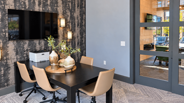 Gallatin apartment for rent - A dining table with chairs and a vase with flowers on it.