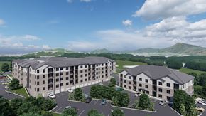 Arden apartment for rent - A large, modern building complex with a parking lot in front.