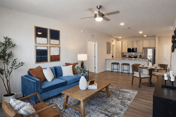 Arden apartment for rent - A living room with a blue couch and a wooden coffee table.