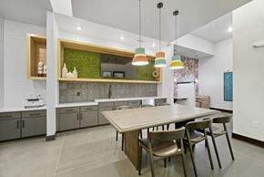 Lawrenceville apartment for rent - A modern kitchen with a wooden table and chairs.