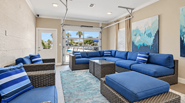 Myrtle Beach apartment for rent - A living room with a blue couch and a painting on the wall.