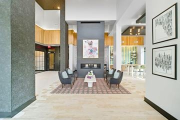 Lawrenceville apartment for rent - A modern living room with a grey sofa set and a coffee table.