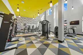 Lawrenceville apartment for rent - A gym with a variety of equipment and a geometric patterned floor.