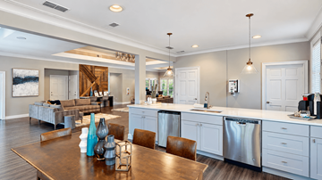 Atlanta triplex for rent - A modern kitchen and living room with a wooden table and chairs.