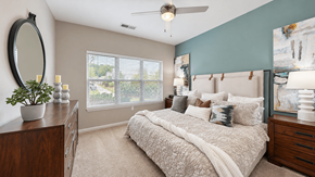 Indian Land apartment for rent - Furnished bedroom with a ceiling fan and large window at Enclave at Bailes Ridge in Indian Land, SC.