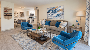 Decatur apartment for rent - A living room with a blue chair and a grey couch.