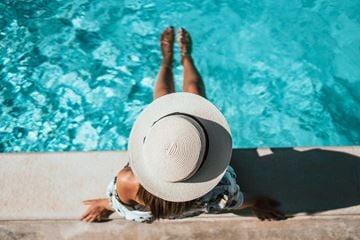 Gallatin apartment for rent - A woman in a hat is relaxing by the pool.