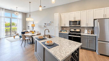 Carmel apartment for rent - A kitchen with a table and chairs in front of a window.