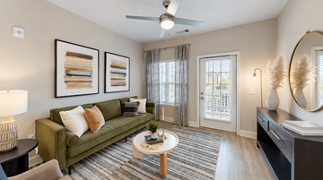 Cartersville apartment for rent - A living room with a green couch and a coffee table.