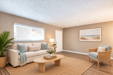 Largo apartment for rent - A living room with a white sofa, a wooden coffee table, a wicker chair, and a painting on the wall.