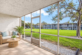 Largo apartment for rent - Exterior of Waterchase Apartments in Largo, FL, with trees beneath a blue sky.