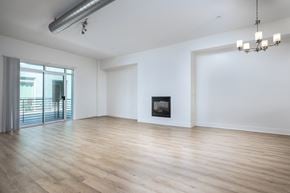 Glendale townhouse for rent - an empty living room with white walls and a fireplace