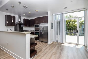 Glendale townhouse for rent - a kitchen with a stainless steel refrigerator and a door to a patio