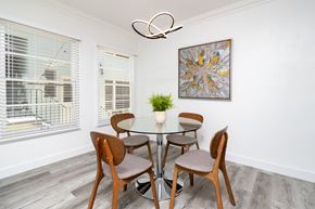 Los Angeles apartment for rent - a dining room with a glass table and chairs and a ceiling fan