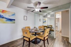 Carson apartment for rent - a dining room with a table and chairs and a ceiling fan