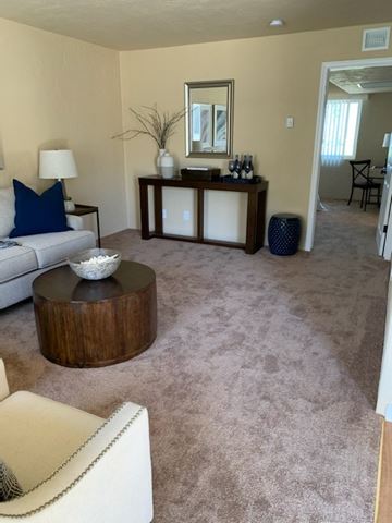 San Pedro apartment for rent - A living room with a white couch and a wooden coffee table.