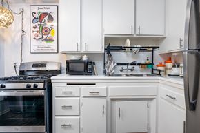Los Angeles apartment for rent - a kitchen with white cabinets and a stove and a sink