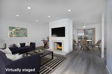 Los Angeles apartment for rent - A modern living room with a fireplace and a painting on the wall.