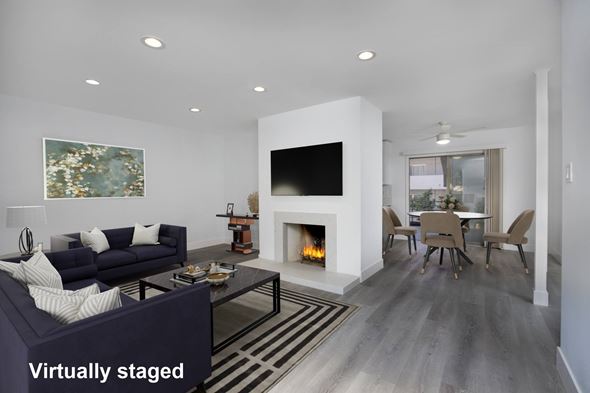 Los Angeles apartment for rent - A modern living room with a fireplace and a painting on the wall.