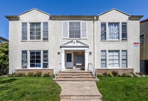 Beverly Hills triplex for rent - a large white building with a blue sky in the background